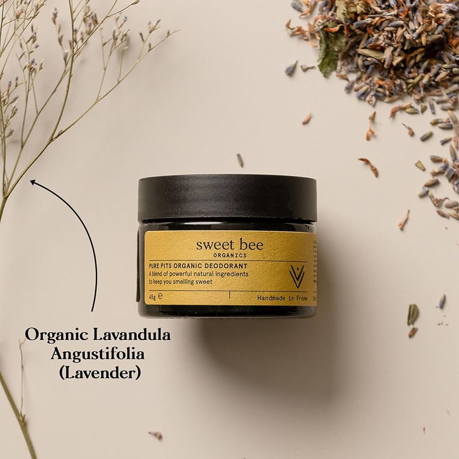 Sweet Bee organic deodorant jar with lavender flowers on a light background