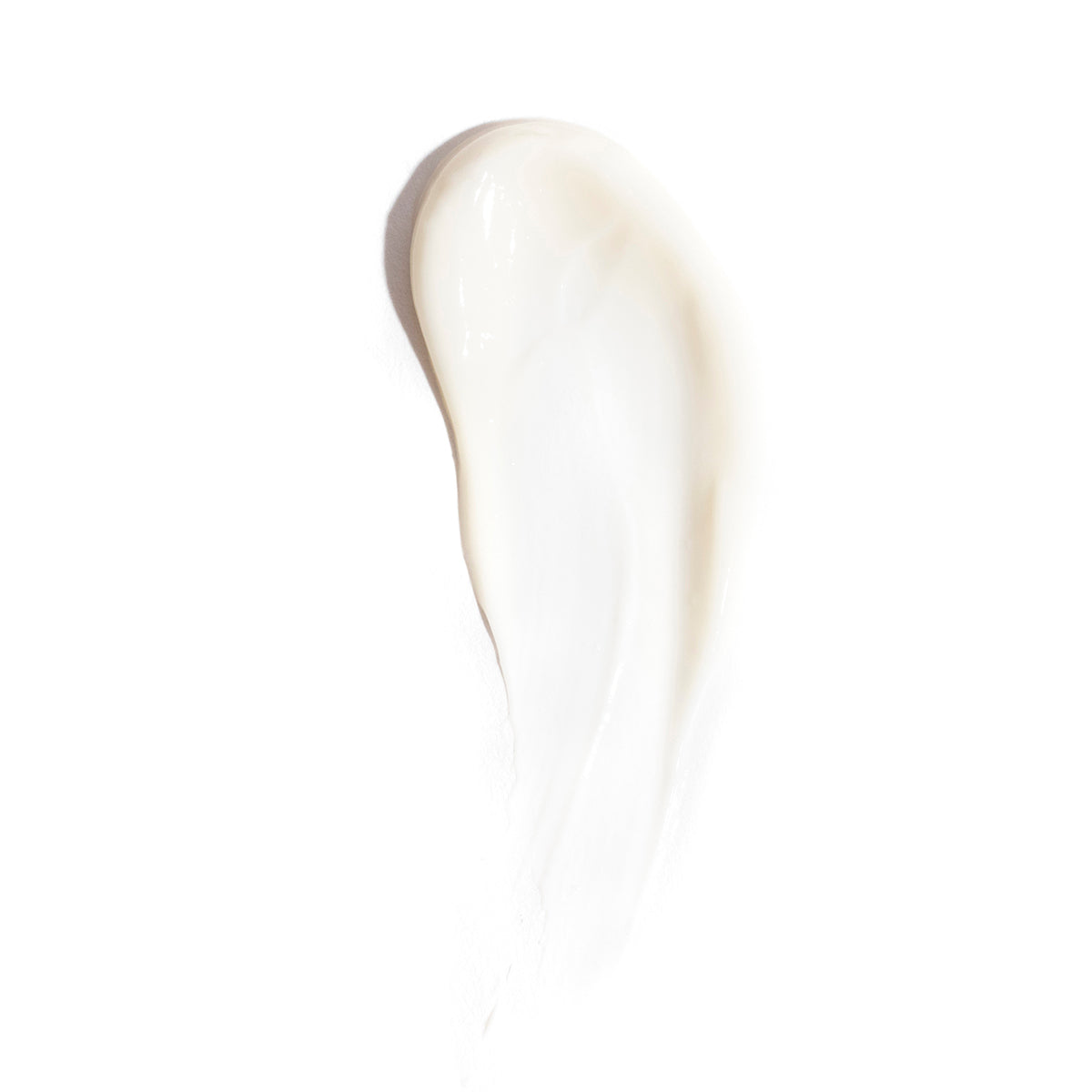Close-up of a smooth, white cream smear on a white background