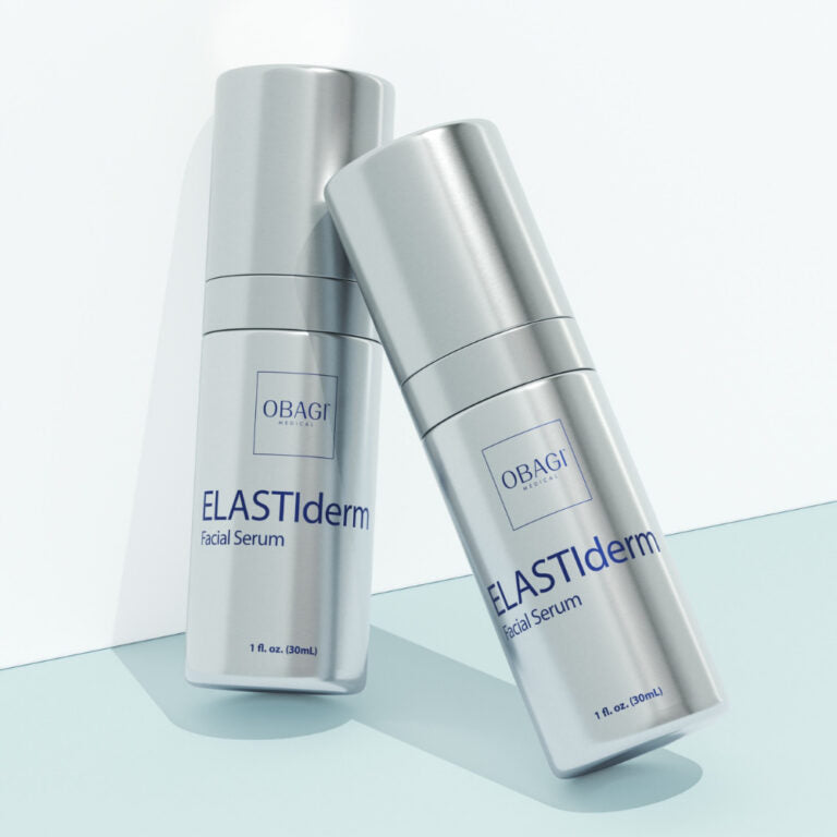 Two bottles of Obagi ELASTIderm Facial Serum on a light blue background