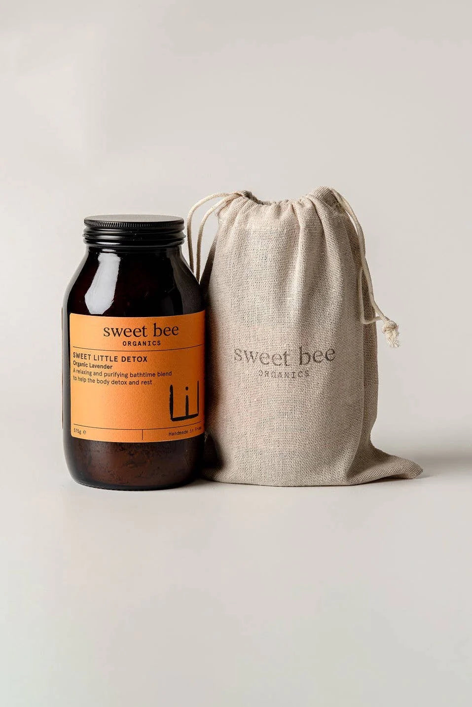 Jar of 'Sweet Little Detox' with a drawstring bag labeled 'sweet bee' on a light background
