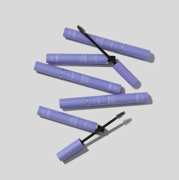 Purple mascara tubes with brushes on a light gray background Obagi branded