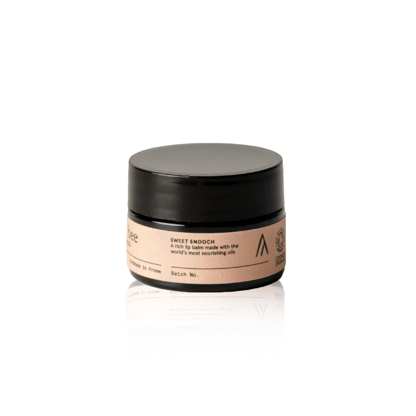 Cosmetic jar with black lid and beige label on a light gray background