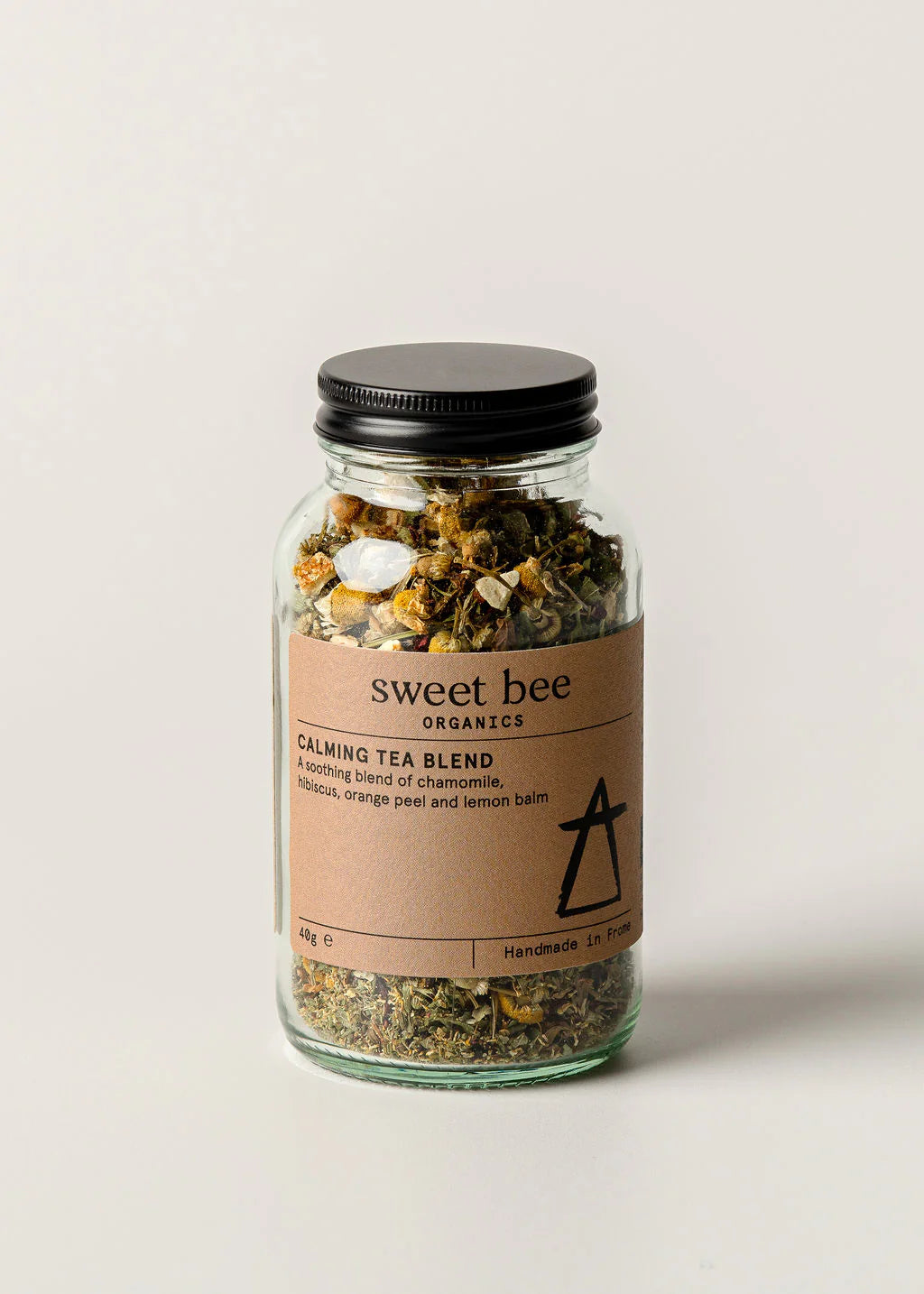 Jar of 'sweet bee' calming tea blend on a light background