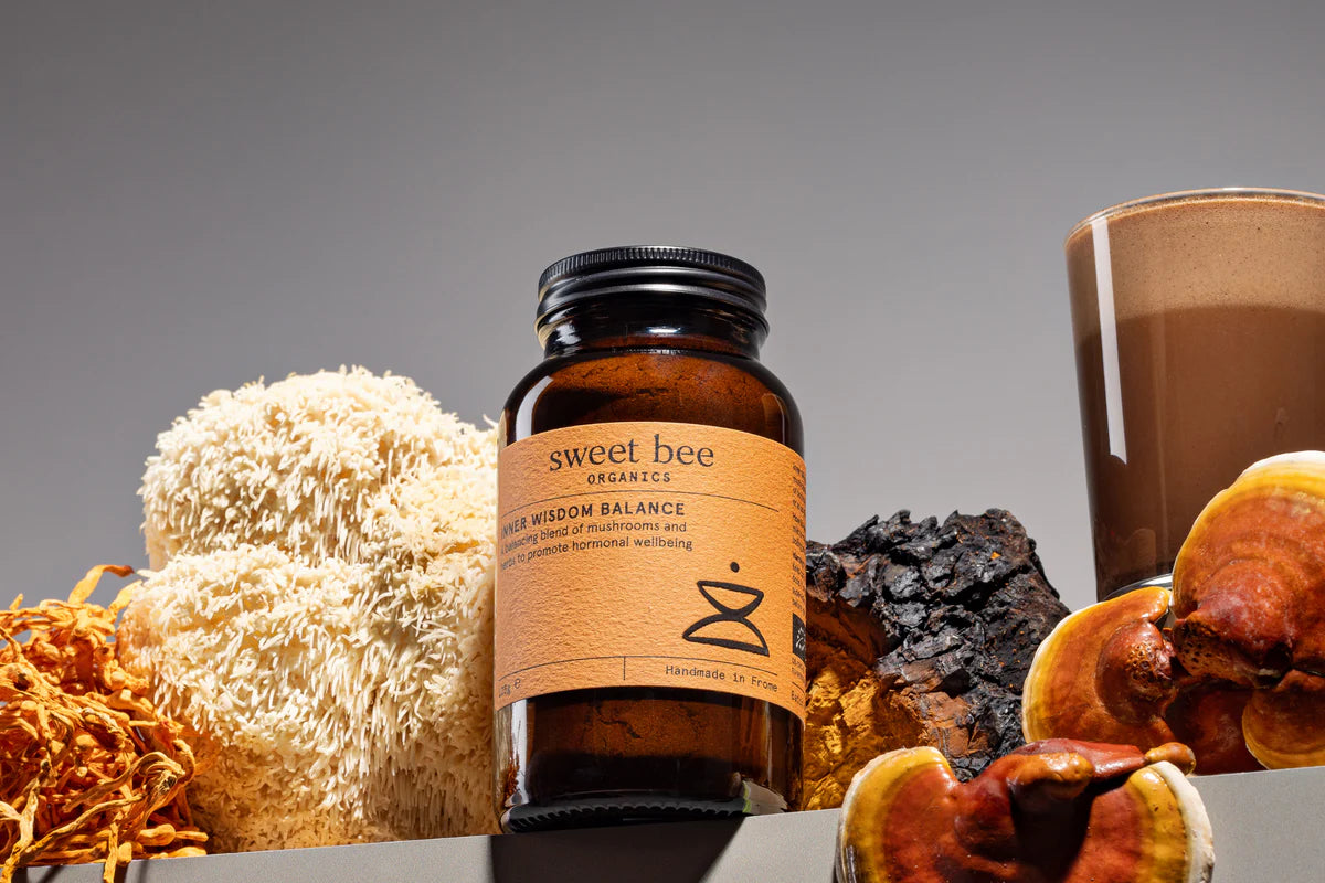 Bottle of 'sweet bee' Inner Wisdom with natural elements on a gray background