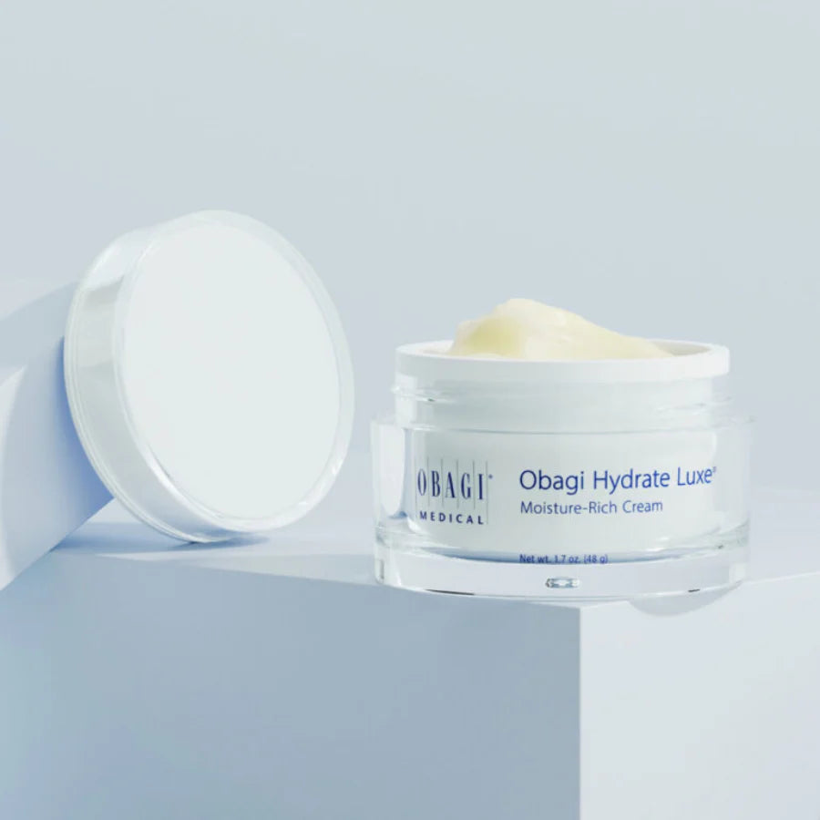 Obagi Hydrate Luxe cream jar on a light blue background