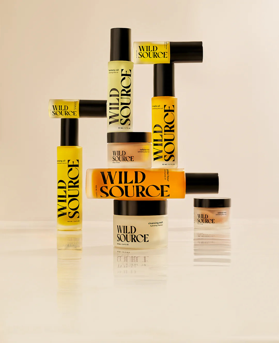 Collection of Wild Source hair care products on a beige background