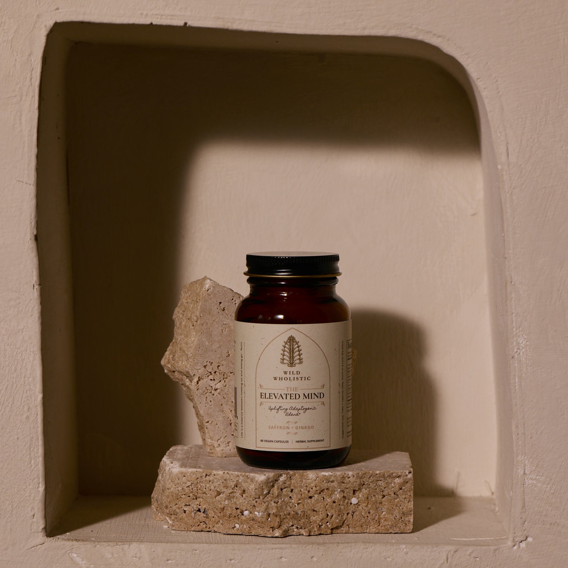 Jar labeled 'Elevated Mind' on a stone block in a recessed wall.