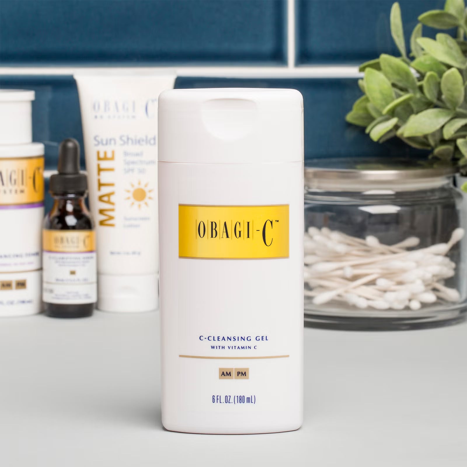 Obagi-C skincare products on a surface with a plant in the background
