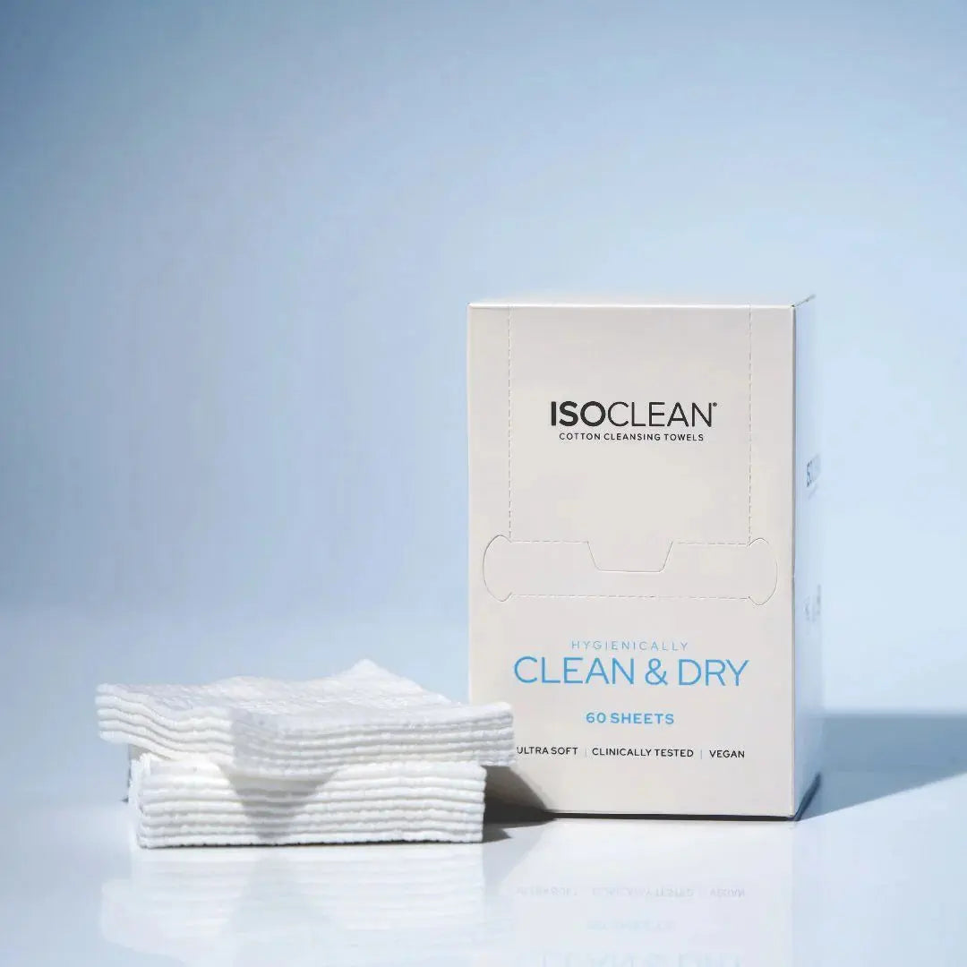 Box of ISO CLEAN cotton cleansing towels with white cotton sheets on a light blue background