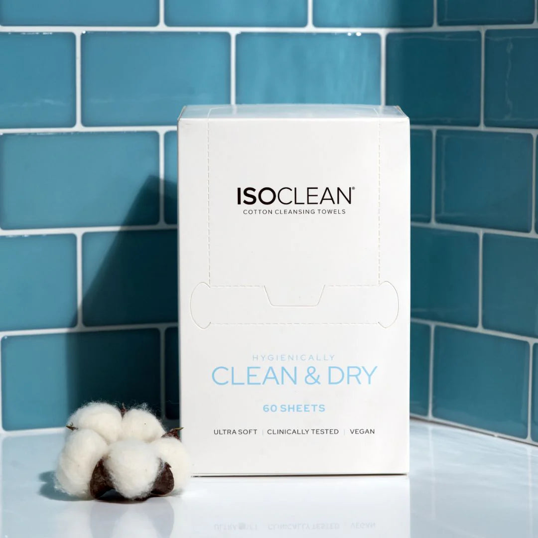 ISO CLEAN cotton cleansing towels packaging with cotton balls against a blue tiled wall.