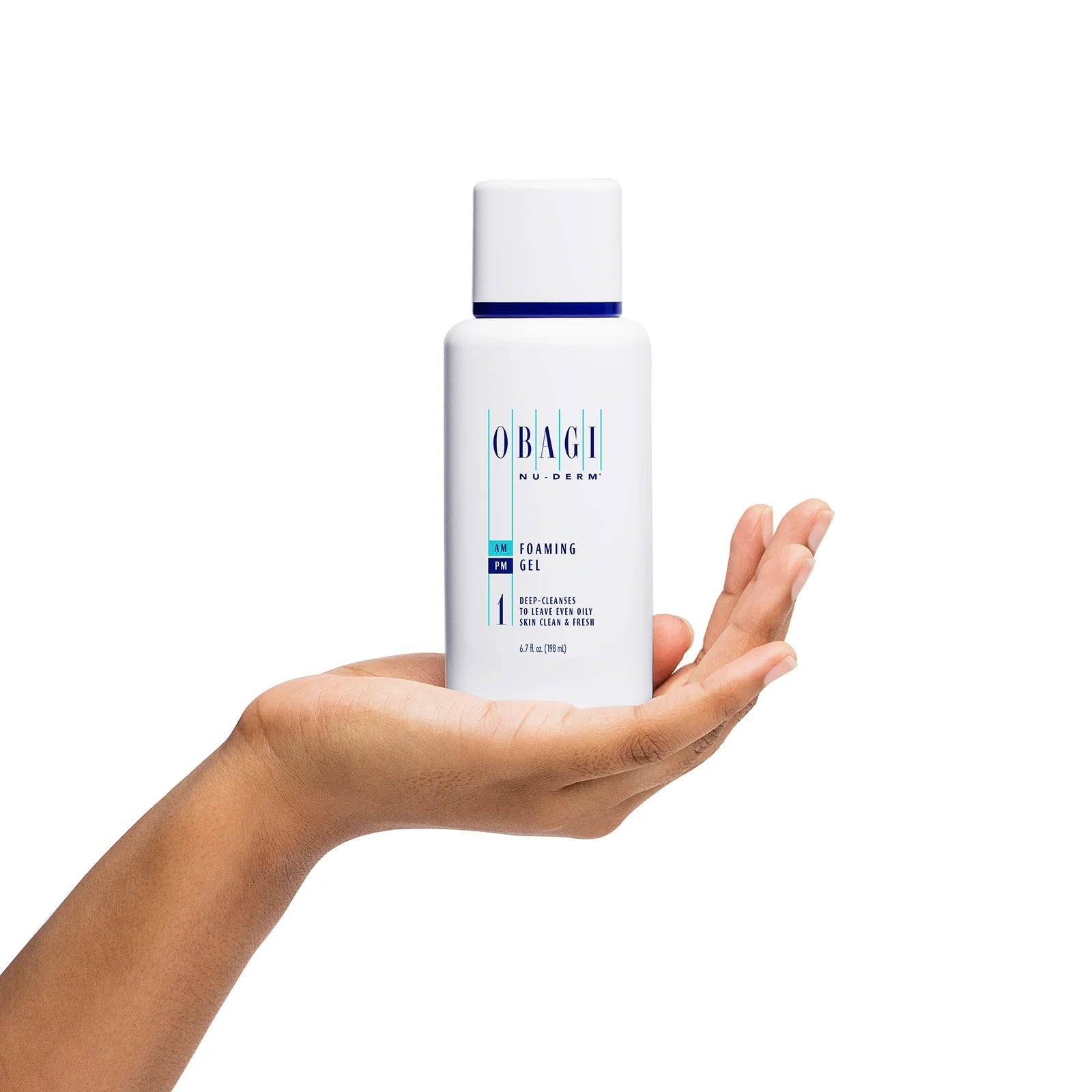 Obagi Nu-Derm Foaming Gel held in a hand against a white background