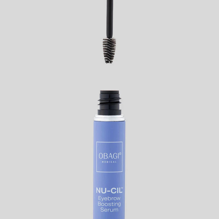 Obagi NU-CIL Eyebrow Boosting Serum with applicator on a gray background