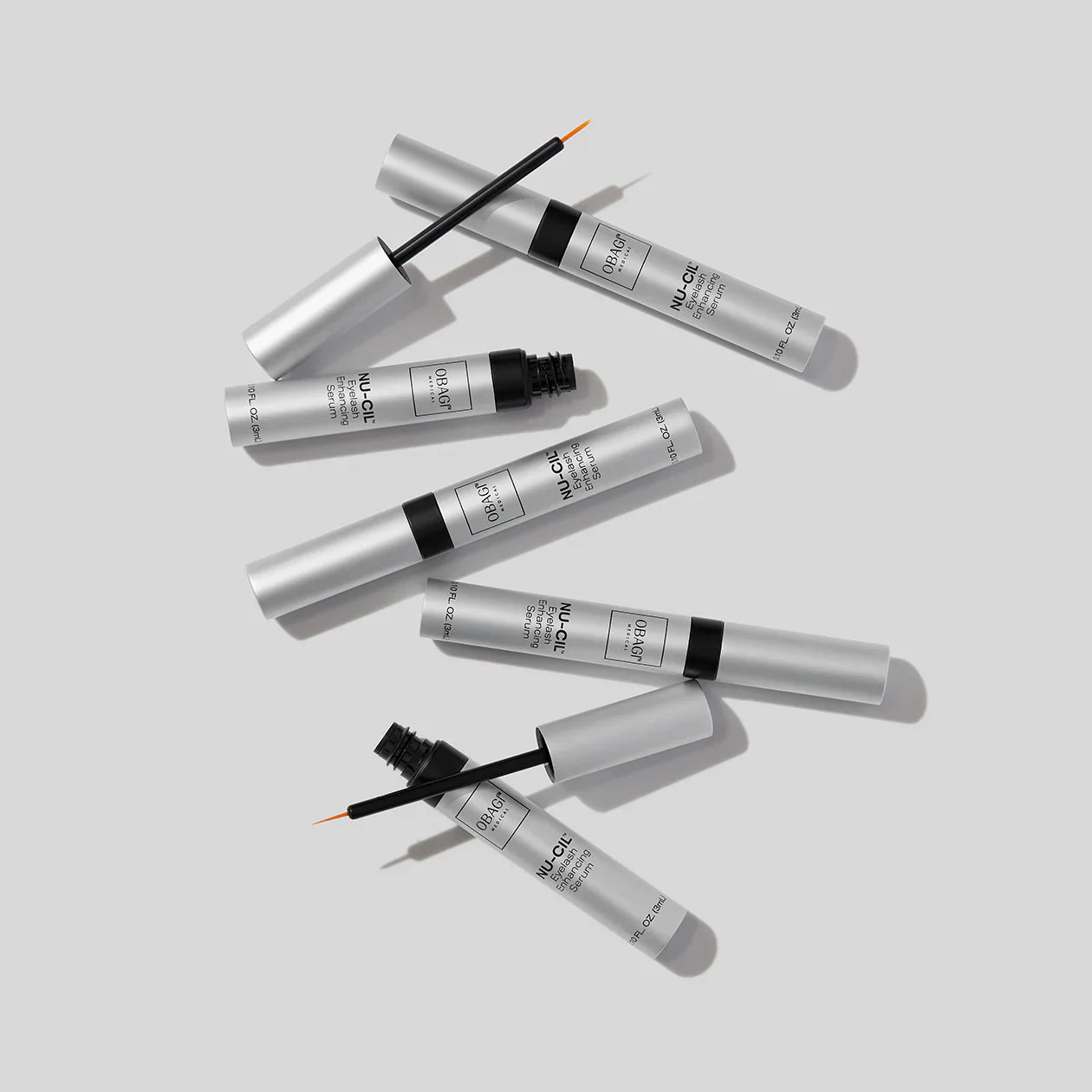 Eyeliner products with applicators on a light gray background