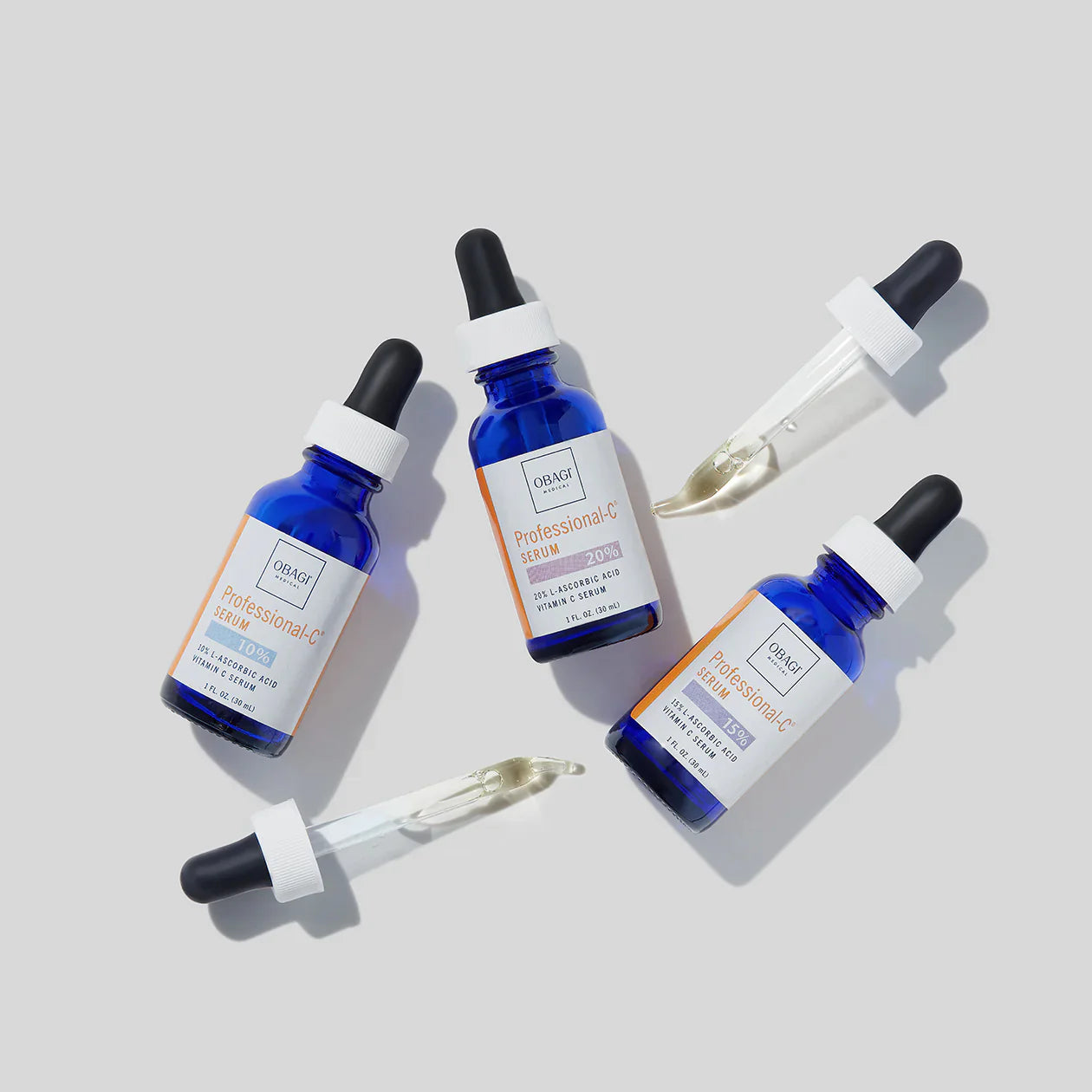 Four Obagi skincare serum bottles with droppers on a light gray background