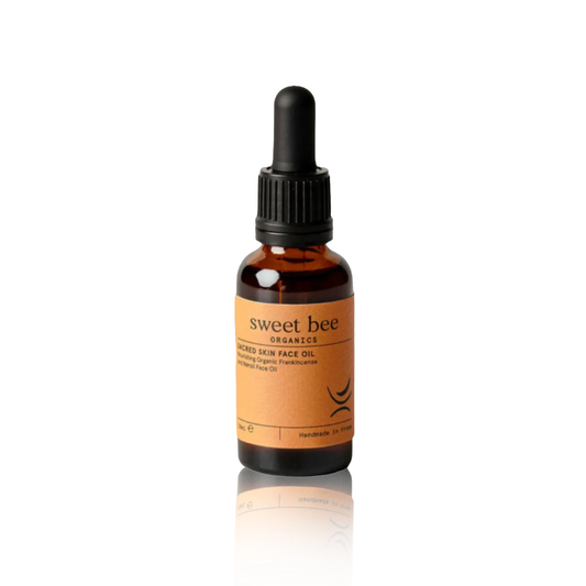 Bottle of sweet bee Organics face oil on a white background