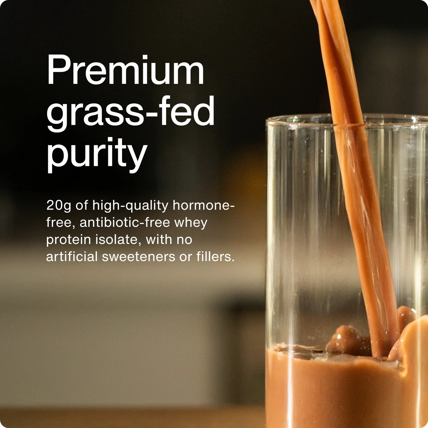 Glass of chocolate milk being poured with text about premium grass-fed purity and protein content.