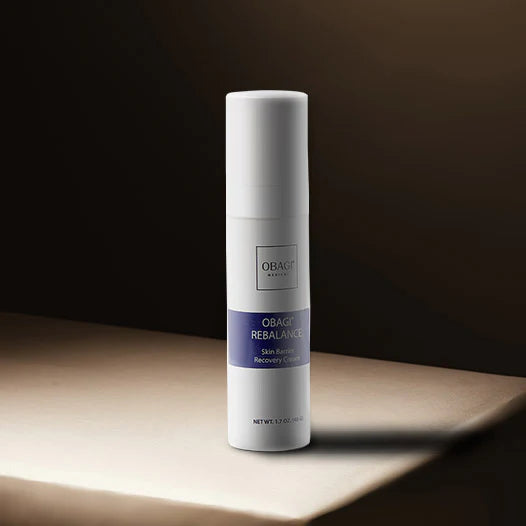 Obagi Rebalance Recovery Cream bottle on a wooden surface with a dark background
